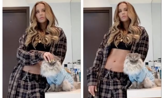Kate Beckinsale, 48, flaunts her toned abs while wearing a black crop top and tartan pyjamas
