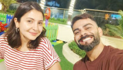 Virat Kohli smiles cheekily as he poses with wife Anushka Sharma
