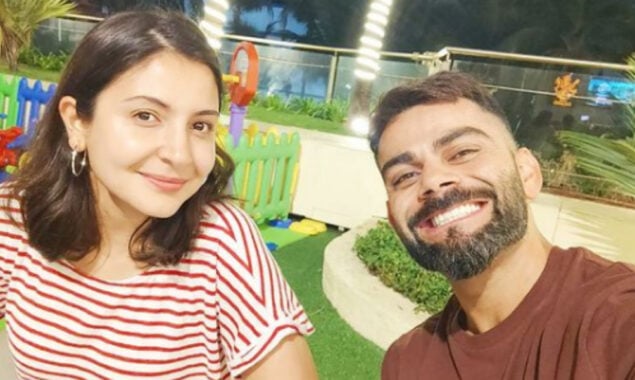 Virat Kohli smiles cheekily as he poses with wife Anushka Sharma