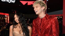 Megan Fox cheers on her fiance, Machine Gun Kelly, as he performs outside hotel