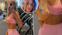 Khloé Kardashian shows off her abs while working out in a matching pink outfit