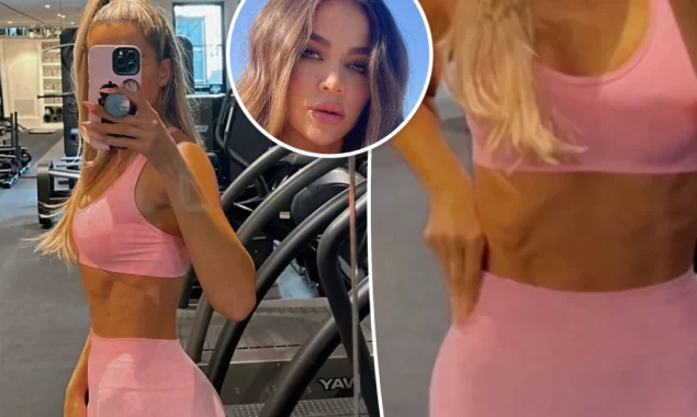 Khloé Kardashian shows off her abs while working out in a matching pink outfit