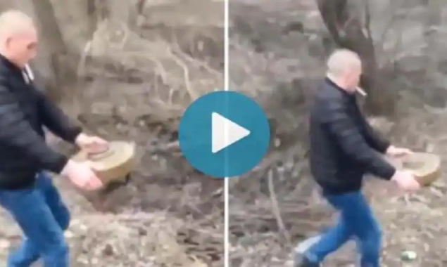 Watch Video: A Ukrainian man moves a land mine with bare hands while smoking