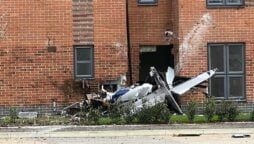 A plane crashes into a block of flats, and the pilot is transported to the hospital
