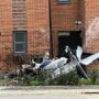 A plane crashes into a block of flats, and the pilot is transported to the hospital