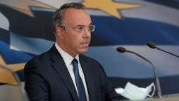 Greece repays last tranche of IMF bailout loans early, finance minister