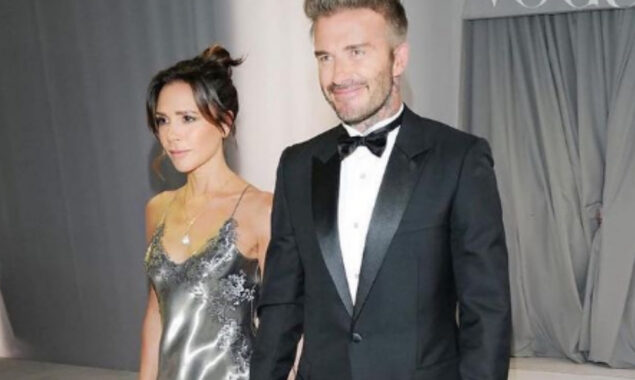 Victoria Beckham smiles as she shows off her full-length wedding gown