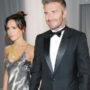 Victoria Beckham smiles as she shows off her full-length wedding gown