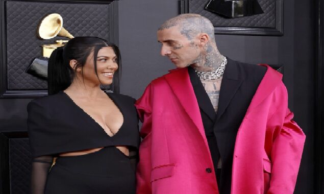 Fans of Kourtney Kardashian believe she is PREGNANT after noticing a ‘bump’ during her PDA-filled Grammys date with Travis Barker