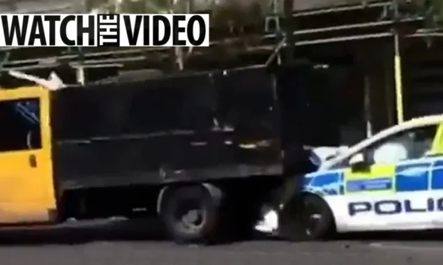 Before policemen arrive, a tipper truck crashes into a police car in reverse during a traffic check. LOSE IT IN THE OPEN AIR