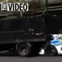 Before policemen arrive, a tipper truck crashes into a police car in reverse during a traffic check. LOSE IT IN THE OPEN AIR