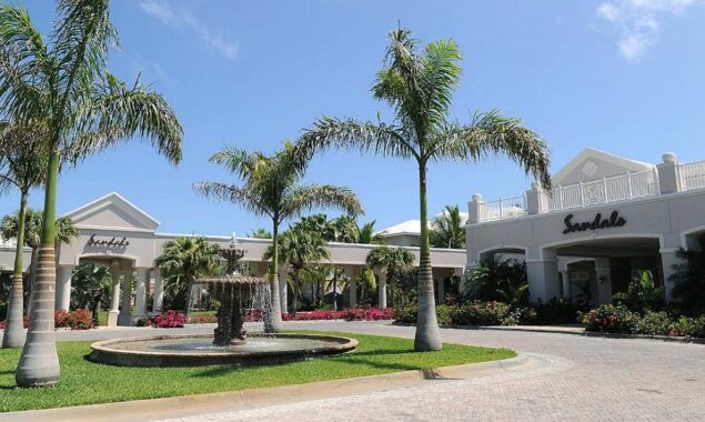An American woman who became ill at a Bahamas resort is now hospitalized in Miami