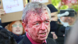 Anti-war protesters spray red crimson paint on Russian envoy to Poland