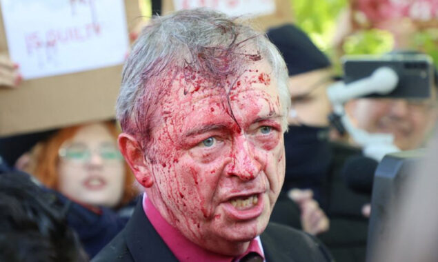 Anti-war protesters spray red crimson paint on Russian envoy to Poland