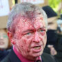 Anti-war protesters spray red crimson paint on Russian envoy to Poland