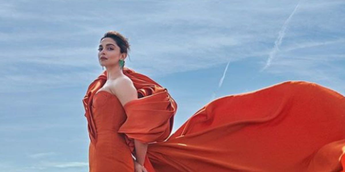 Deepika Padukone brings regal finesse & some skin in an orange gown