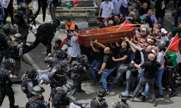 Israeli police beat mourners