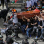 Israeli police beat mourners