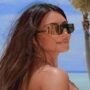 Kim Kardashian shows off her toned legs and trim abs in a pool photo from a ‘lazy Sunday’