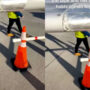 A worker at the airport displays tape that “holds planes together.”