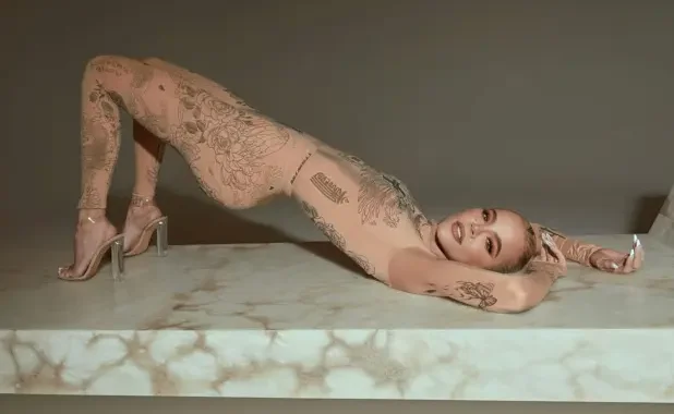 Khloé Kardashian wears a naked catsuit with tattoos all over it