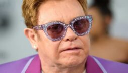 Sir Elton John answers to fans after being photographed in a wheelchair, saying, ‘I’m in great shape.’