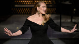 Adele shows off her slim figure in a gorgeous off-shoulder gown