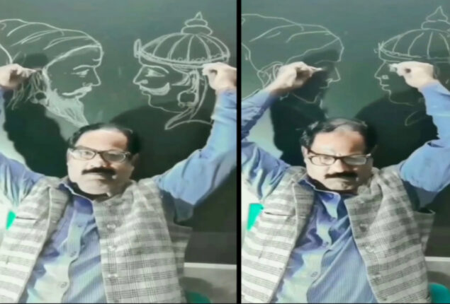 man draws on blackboard