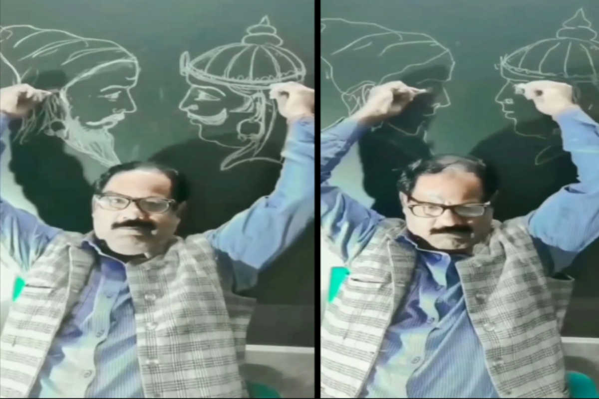 man draws on blackboard
