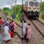 Watch: Woman crosses train track seconds before train arrives