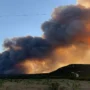 Texas lakeside houses burn in a wildfire in intense heat