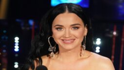 Stunning in an orange maxi skirt and a purple bodysuit, Katy Perry is pictured