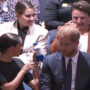 Meghan Markle offers a bottle of water to the coughing woman at UN