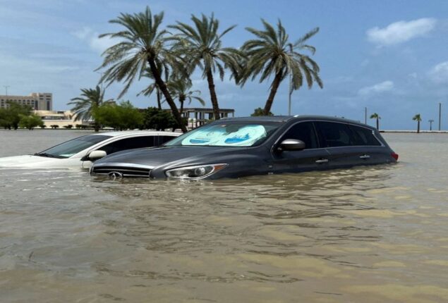 Trapped woman pulled to safety from flooded car