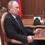 At a war meeting, grimacing Putin grabs the table once more