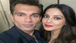 Bipasha Basu with growing baby bump while wearing a green dress