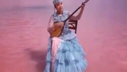 Viral Video: Kazakhstan woman plays music sitting in pink lake