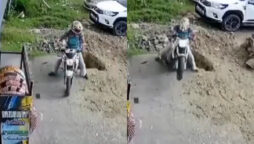 Watch: Man falls into huge pit while driving his bike backwards