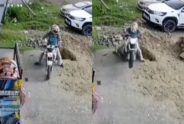 Watch: Man falls into huge pit while driving his bike backwards