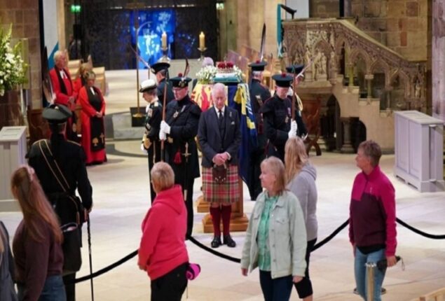 Numerous people stand in line all night to pay their respects as they pass the Queen’s casket