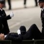 Queen’s funeral: A police officer falls, and is taken away on a stretcher
