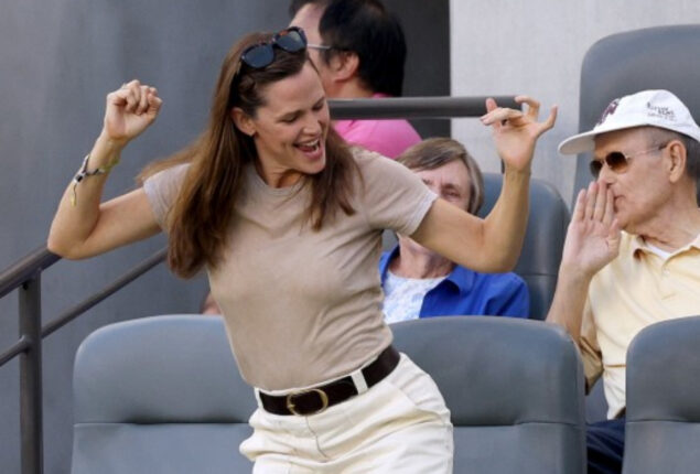 Jennifer Garner shows no sign of despair as she dances off during football match