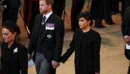 Prince Harry and Meghan Markle hold hands at Queen’s funeral