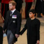 Prince Harry and Meghan Markle hold hands at Queen’s funeral