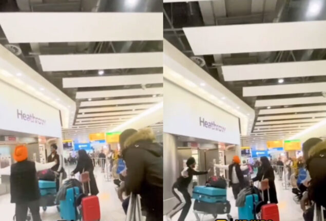Men start bhangra dance after meeting at Heathrow airport