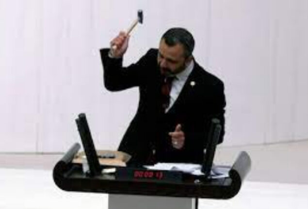 Turkey MP Burak Erbay hammers phone in parliament