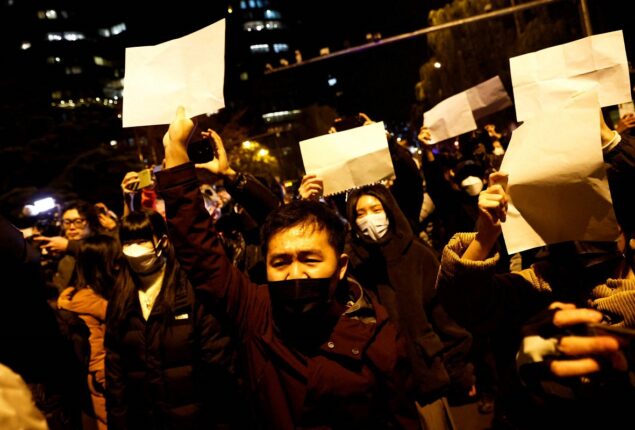 China curbs protesters, modifies COVID