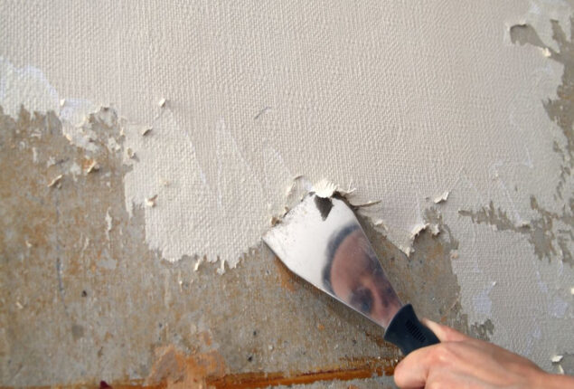 Woman hysterical over 1990s note under wallpaper
