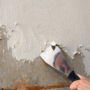 Woman hysterical over 1990s note under wallpaper
