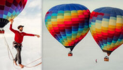 Slackliner between two hot air balloons in Brazil